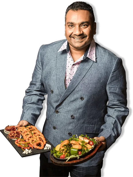 an indian affair chef Gary holding dishes